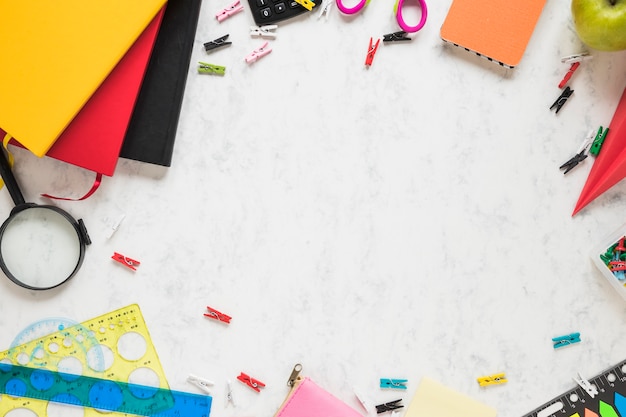 White background with school supplies and textbooks