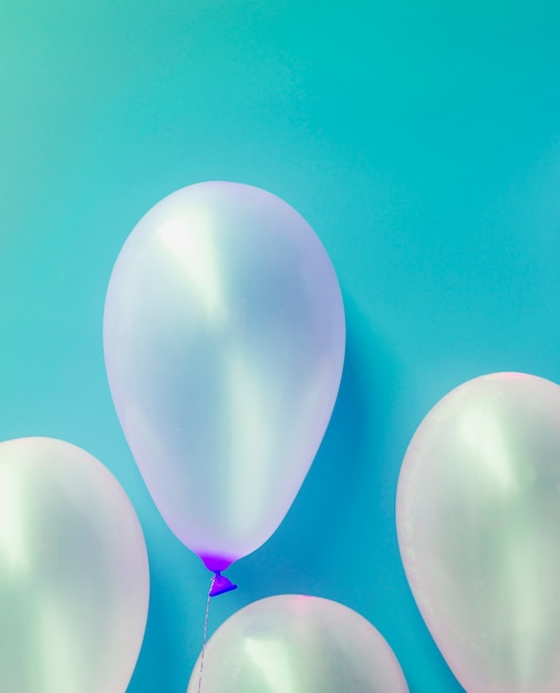 White balloons on blue background