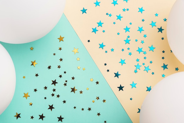 White balloons and confetti stars on colorful background