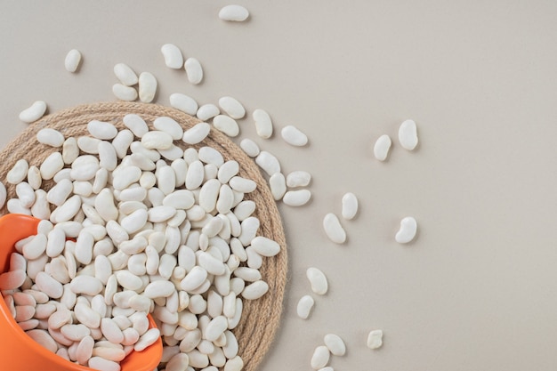 White beans in food trays on concrete.