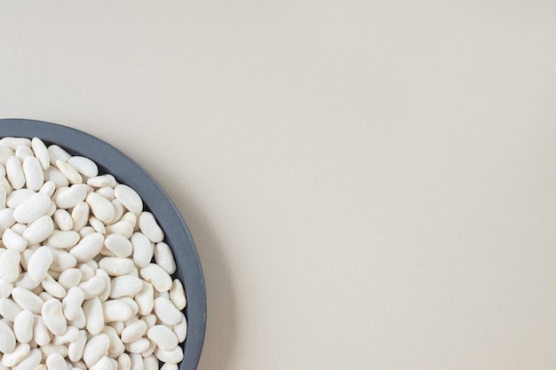 Free photo white beans in food trays on concrete.