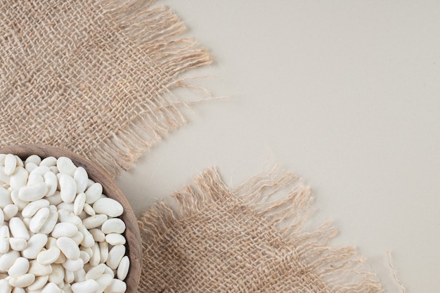 Free photo white beans in food trays on concrete.