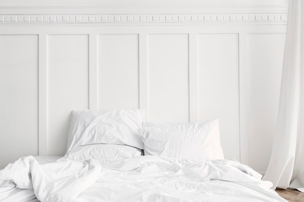 White bed linen in a bed in a bedroom