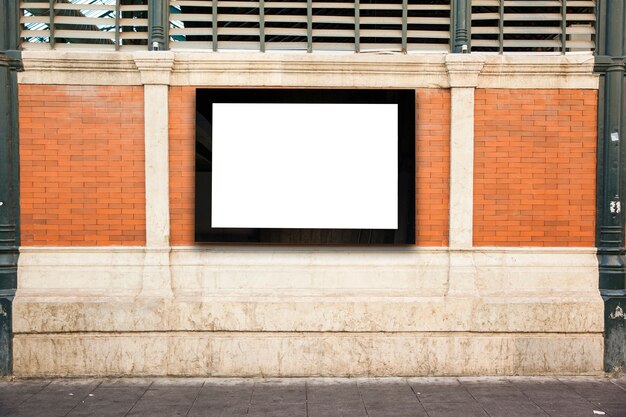 White billboard on wall in city