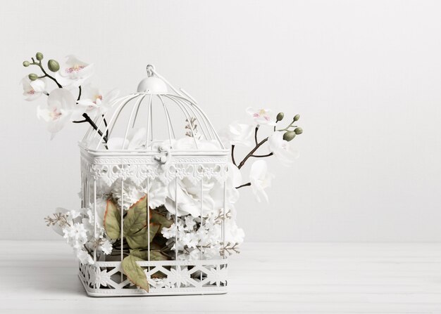 White bird cage full of flowers
