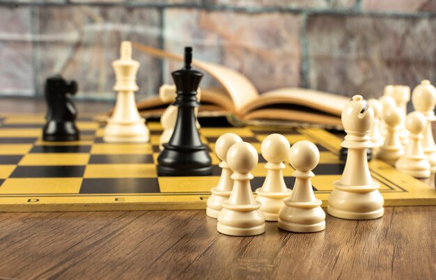 White and black figures position on a chessboard