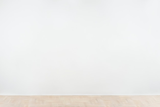 Free photo white blank concrete wall mockup with a wooden floor