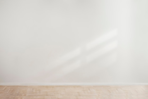 White blank concrete wall mockup with a wooden floor