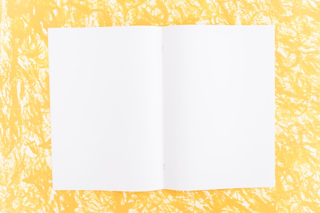 Free Photo white blank page on yellow textured background