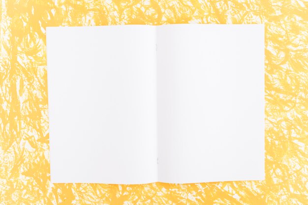 White blank page on yellow textured background