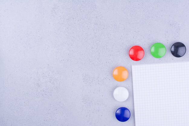 White blank paper with colorful pins around