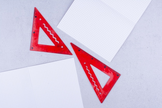 Free photo white blank papers with red rulers on the ground