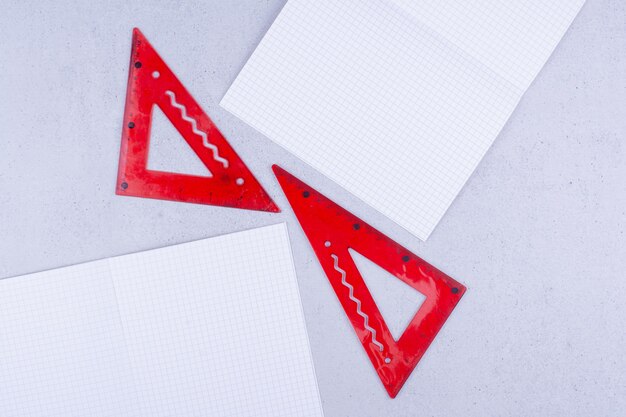 White blank papers with red rulers on the ground