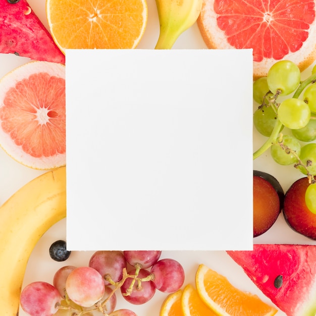 White blank placard over the colorful citrus fruits; grapes and watermelon