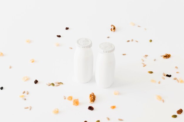 White bottles between dried fruits