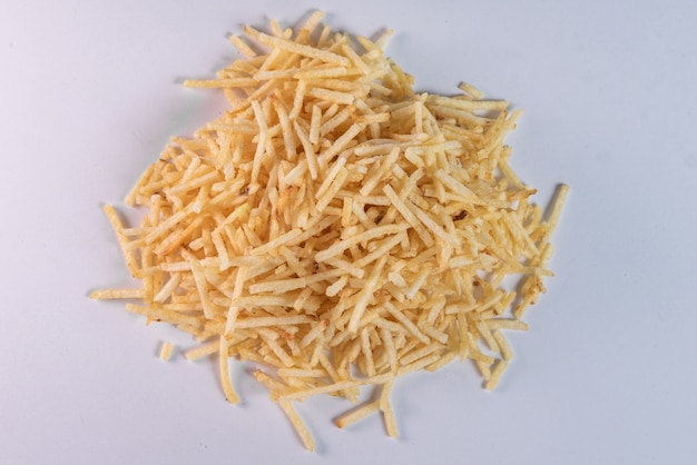 White bowl with potato straw on white background