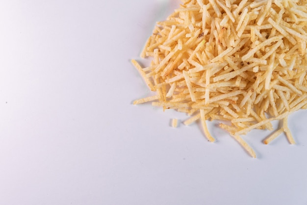 White bowl with potato straw on white background