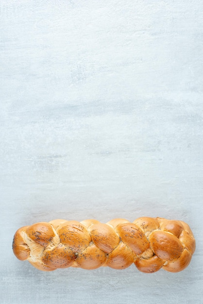 Free photo white braided bread on stone