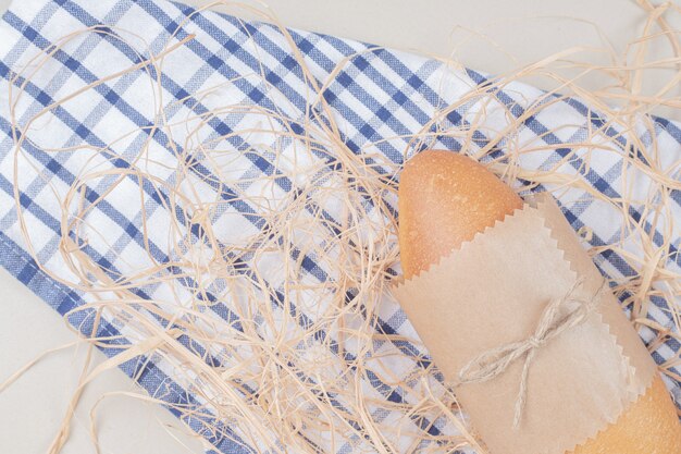 White bread loaf in rope on tablecloth 