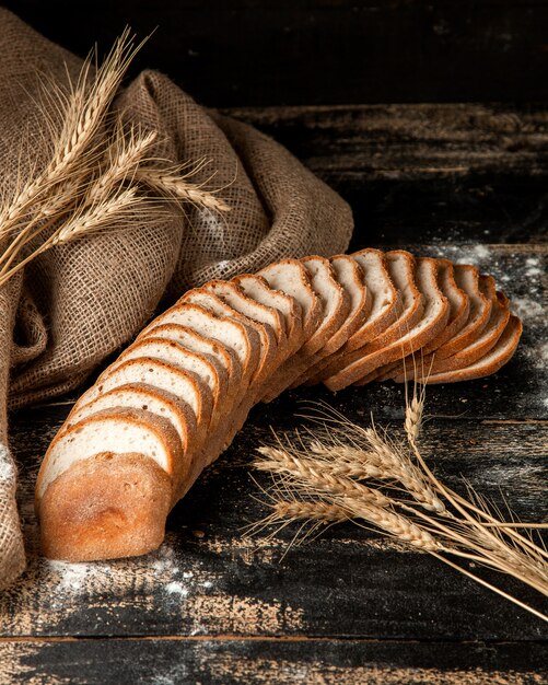 White bread sliced white bread with wheat and flour on table