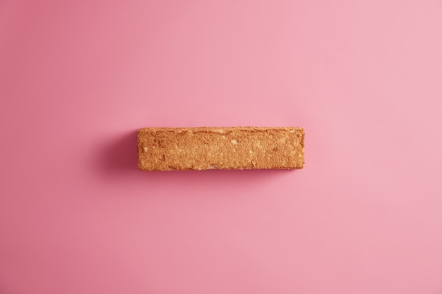 White bread toast with appetizing crust photographed from above, isolated over rosy background. Slice of grain bread. Yummy delicious breakfast. Snack and food. Proper substantial nutrition concept