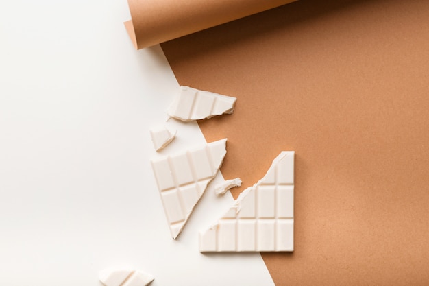 White broken chocolate bar on dual background