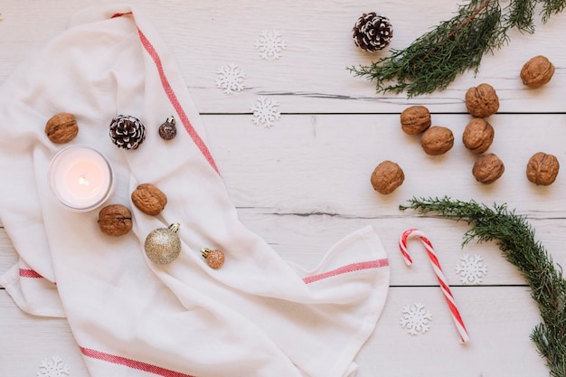 White burning candle with walnuts