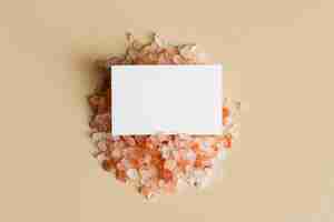 Free photo white business card on orange pebbles