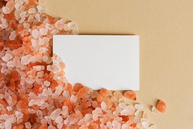 White business card on orange pebbles