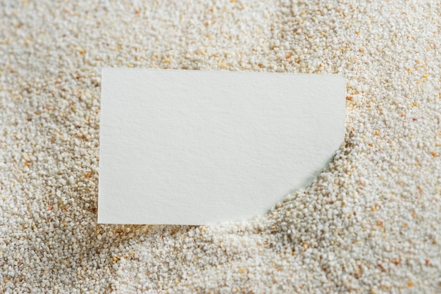 Free photo white business card on sand