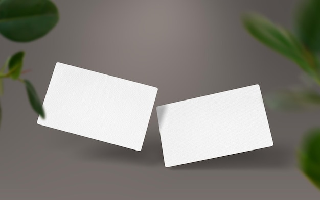 Free photo white business cards with plants on the foreground