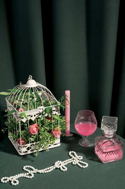 White cage with flowers next to girly arrangement