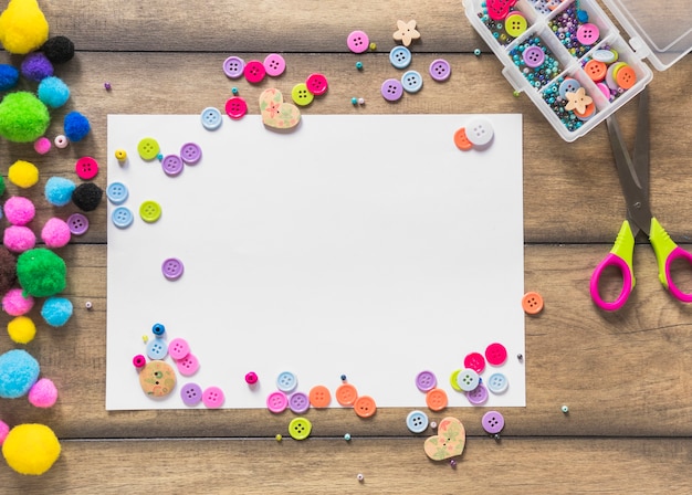 Free photo white card paper decorated with colorful buttons and beads