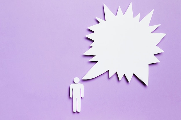 White cardboard man thinking on violet background