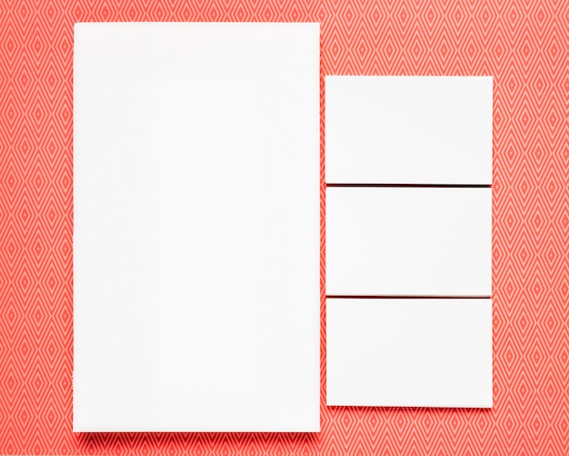 Free photo white cards on orange background