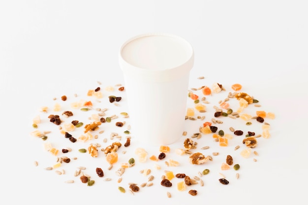 White carton glass between dried fruits and nuts