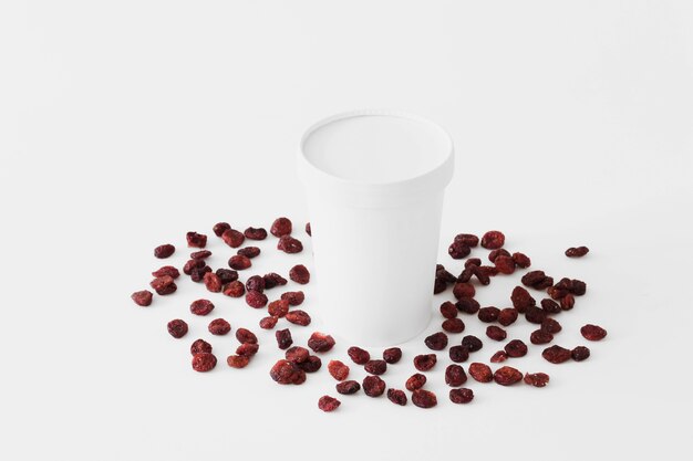 White carton glass between dried fruits 