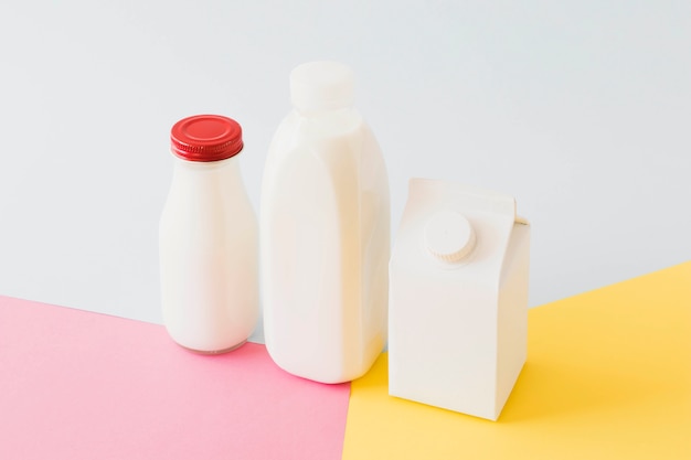 White carton package and bottles on bright board