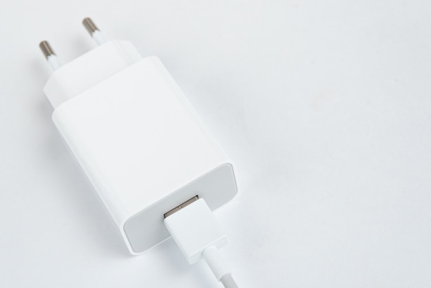 White cell phone charger on the white isolated background - With usb cabe