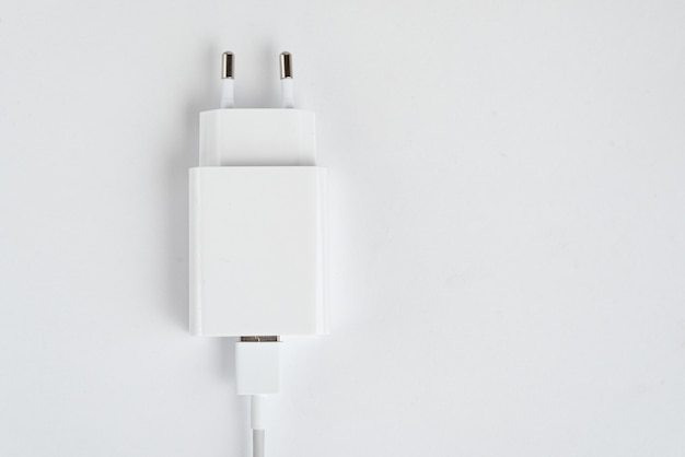 White cell phone charger on the white isolated background - With usb cabe