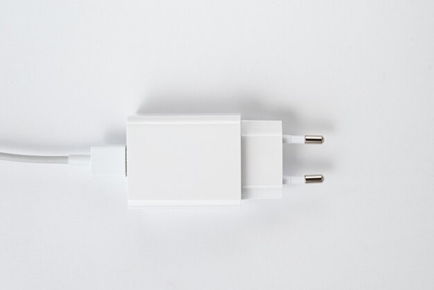 White cell phone charger on the white isolated background - With usb cabe
