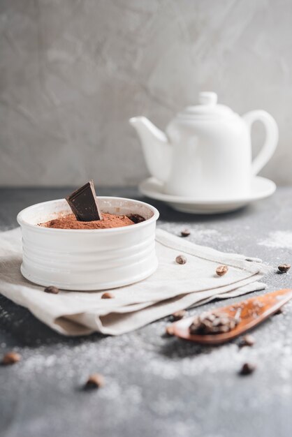 White ceramic bowl of chocolate moose dessert with coffee beans