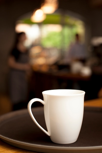 White ceramic coffee mug on tray at coffee shop