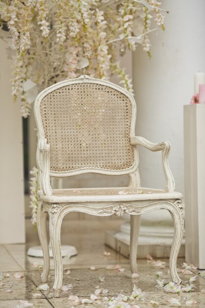 White chair stands on white petals outside