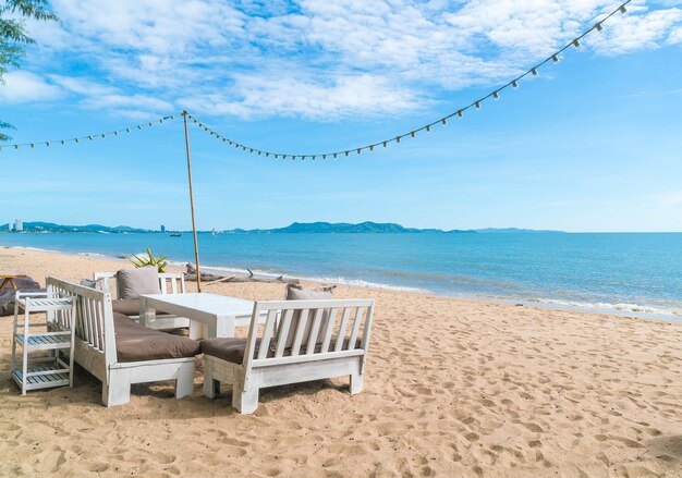 white chairs and table on beach