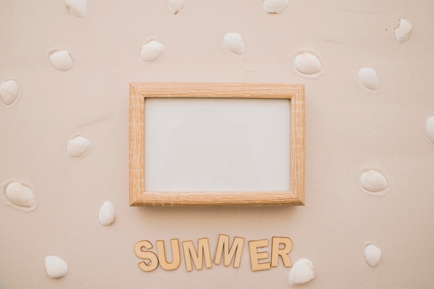 White chalkboard and seashells on sand