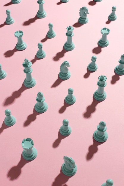 Белые шахматные фигуры на розовом фоне