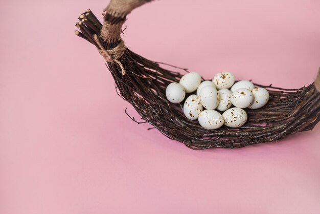 White chicken eggs in basket on table