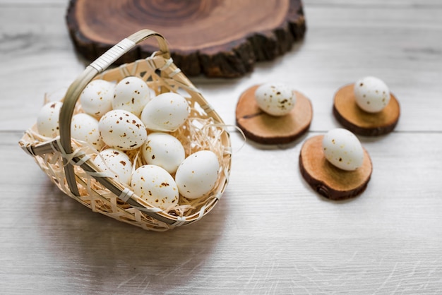 White chicken eggs in basket on table