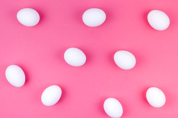 White chicken eggs scattered on table